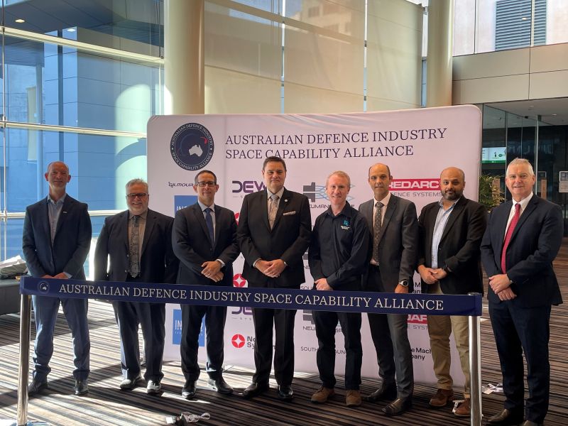 Industry stakeholders in front of the Australian Defence Industry Space Capability Alliance banner at the 13th Australian Space Forum