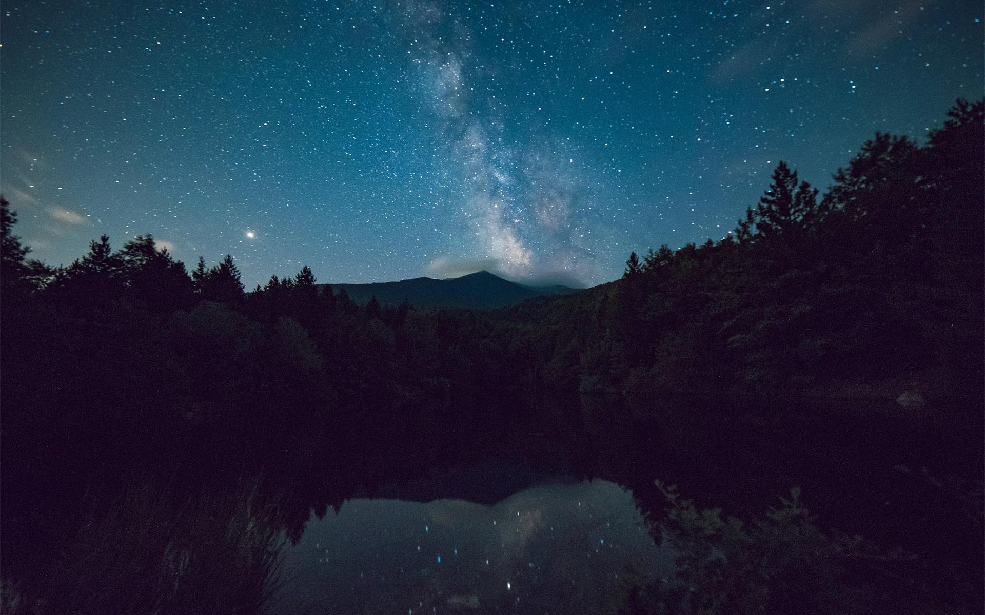 Stars over mountains and a lake